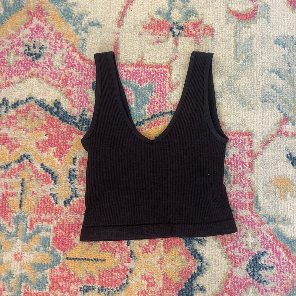 4 women’s tank tops 2 black, 1 pink, & 1 green cropped top.